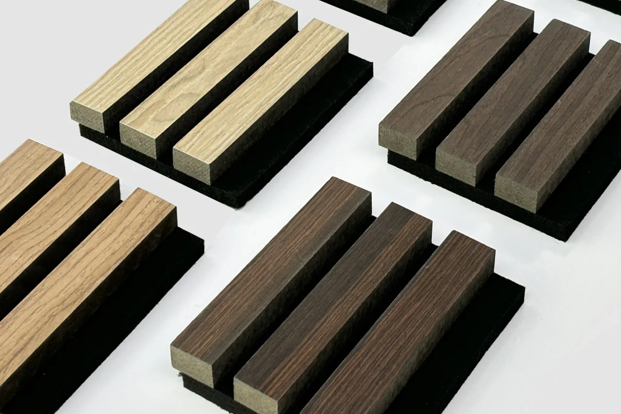 Panels in a range of wood shades, each arranged as parallel strips on black square bases, are displayed on a light gray background.