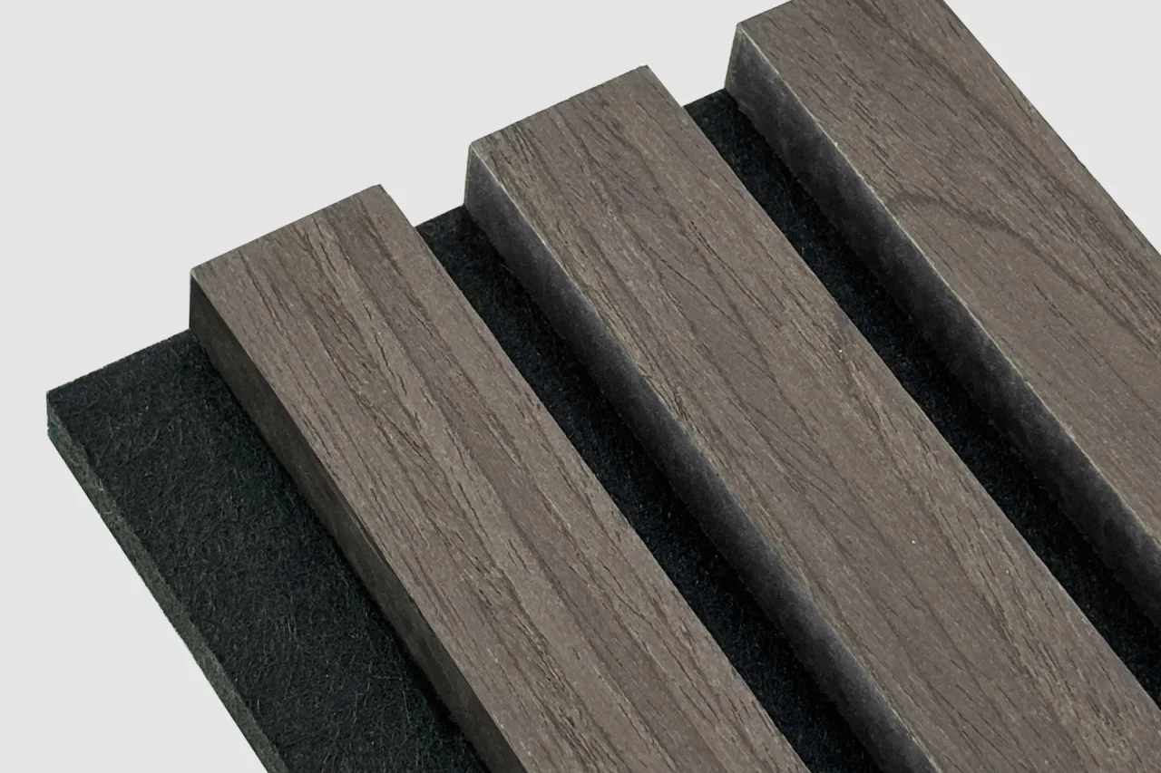 A close-up of a panel with four parallel, rectangular Stilj™ Acoustic Timber Slats mounted on a black backing, displayed diagonally on a plain light gray background.